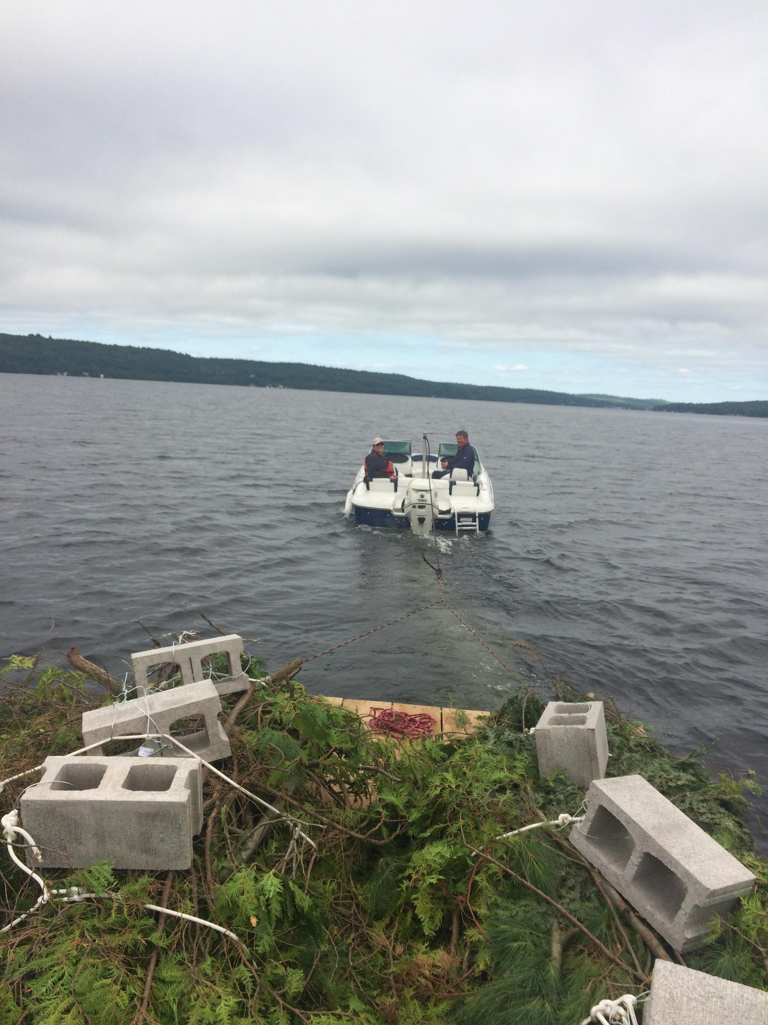 MPOA V.P. Bob Reid & Lake Steward Vern Haggerty, along with Melissa Dakers of Watersheds Canada towing the bundles to the various pre-determined places on the lake